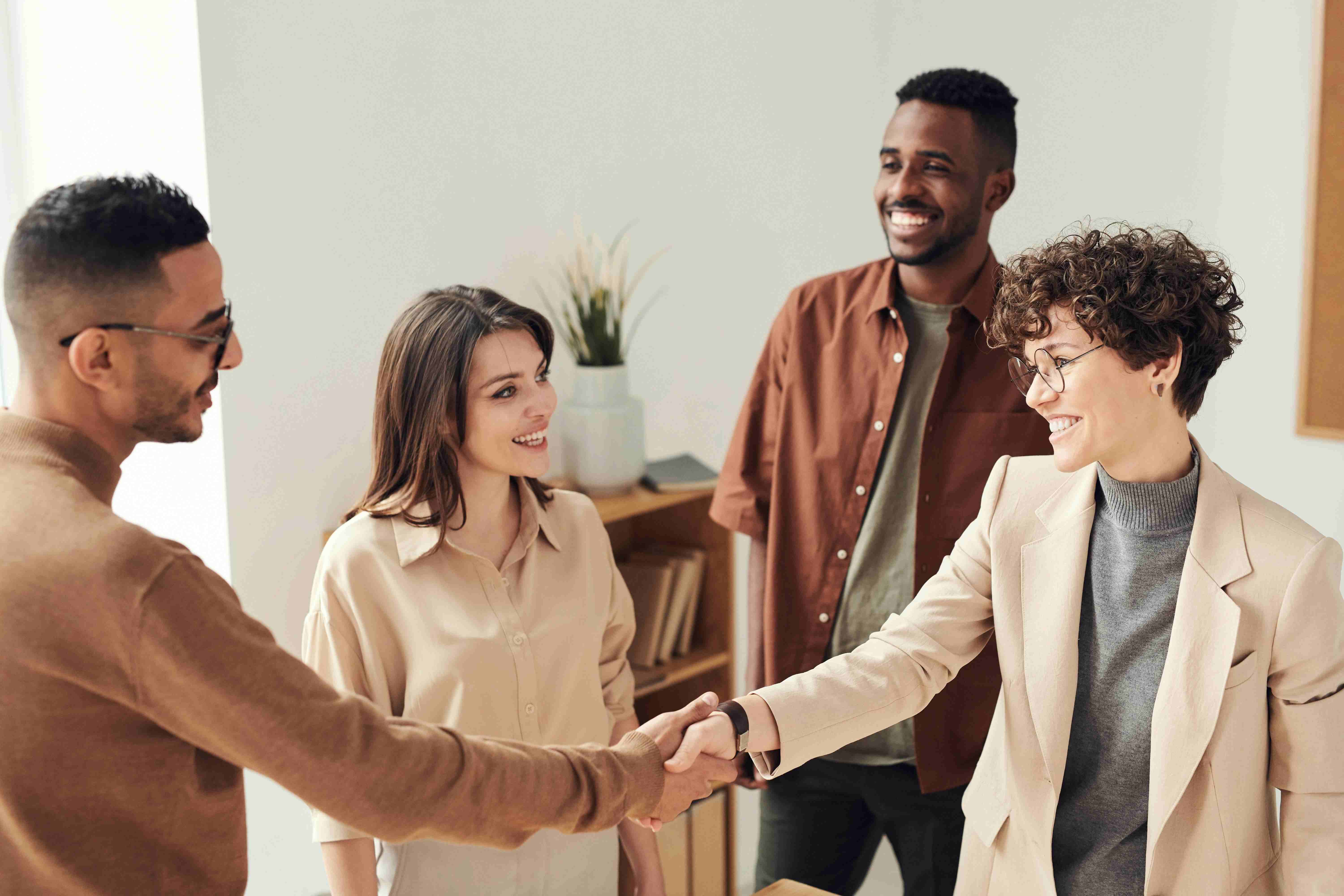 Business owner consulting with financial advisors about preparing for business sale in modern office setting
