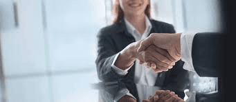 Professional handshake representing successful completion of M&A process